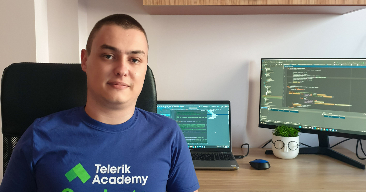 photo of ivan with telerik academy alpha graduation t-shirt in front of a computer screens with code