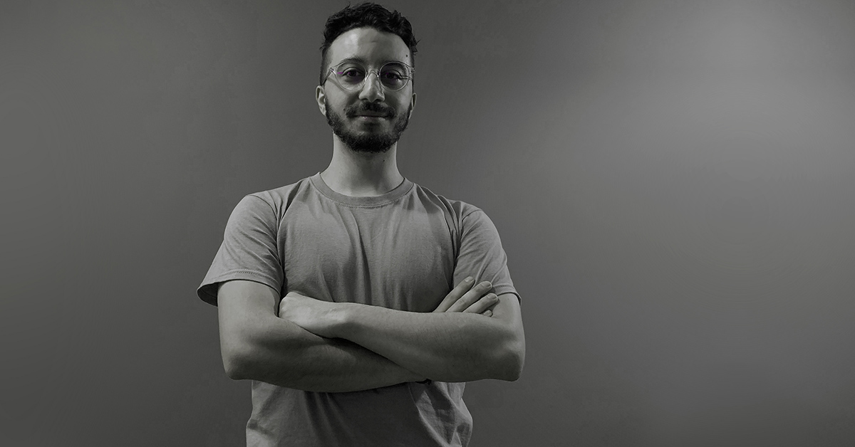 a black and white photo of bogomil, a telerik academy alpha javascript graduate in front of a grey wall