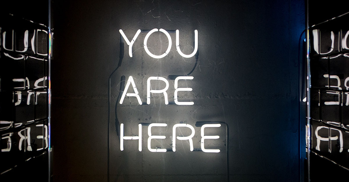A neon sign you are here